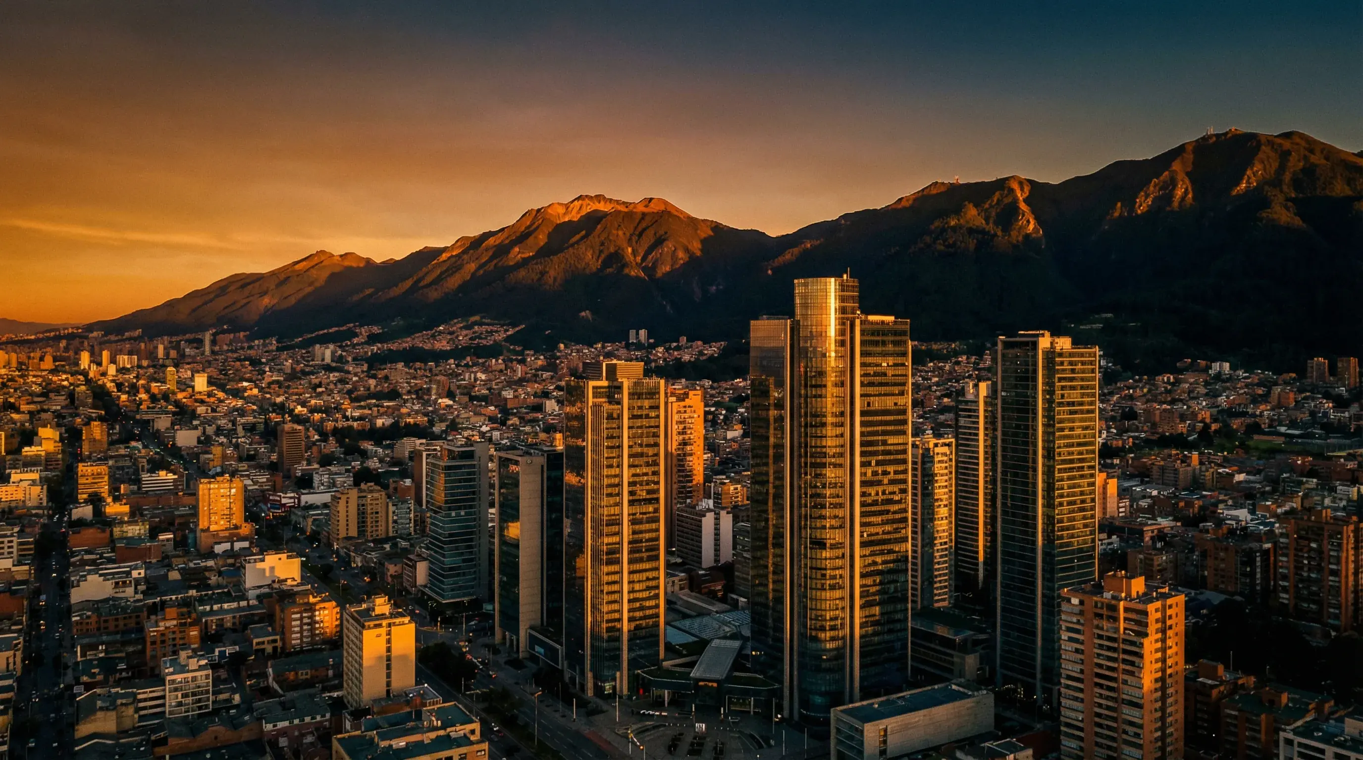 Bogotá financial district at golden hour with mountains in the background